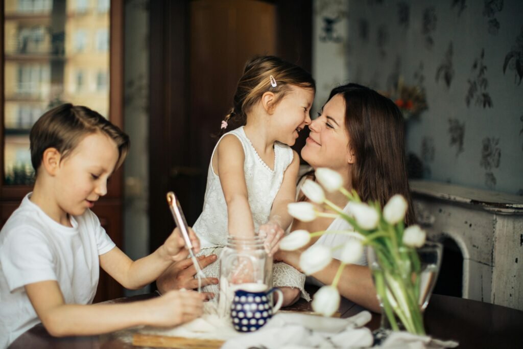 pexels-photo-3806953-3806953 A joyful moment of a mother baking with her children in a cozy home environment.